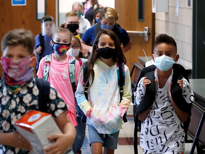 Who has the power to say kids do or don’t have to wear masks in school – the governor or the school district? It’s not clear