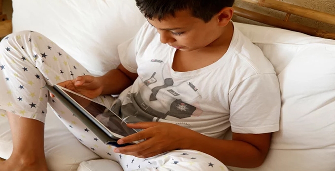 If your kid is home sick from school, is unlimited screen time OK?
